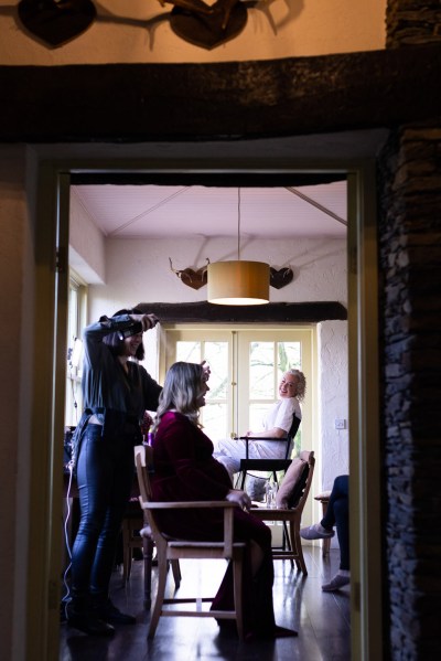 one of the bridesmaids gets her hair and makeup done