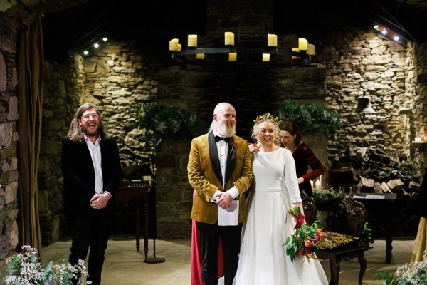 bride and groom are pronounced husband and wife as they look out to their guests