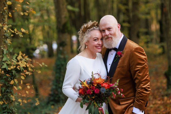 Bride and groom in forest setting hugging