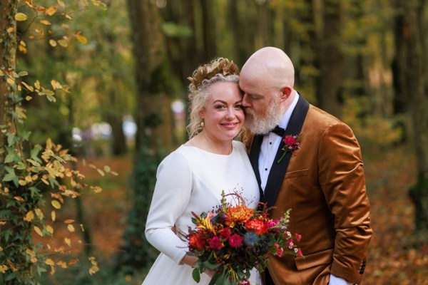 Bride and groom in forest setting hugging