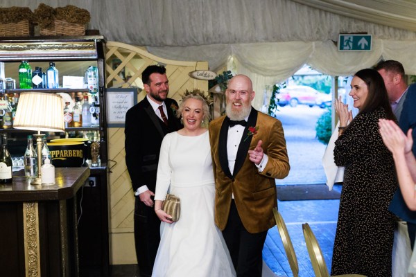 bride and groom enter ballroom together