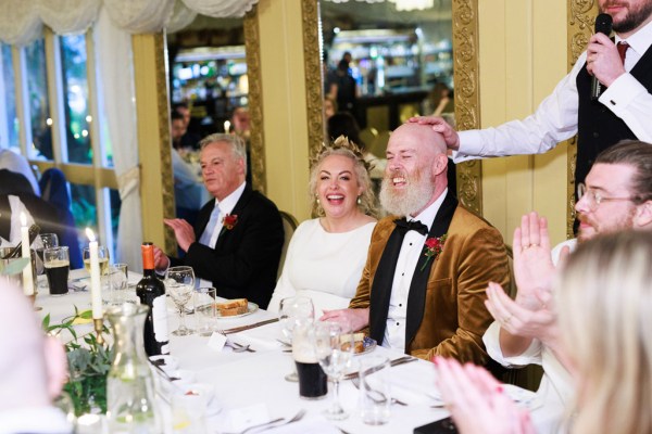 bride groom and father sit at the dining room table together