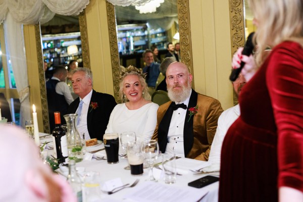 bridesmaid gives speech bride groom father sit at dining room table