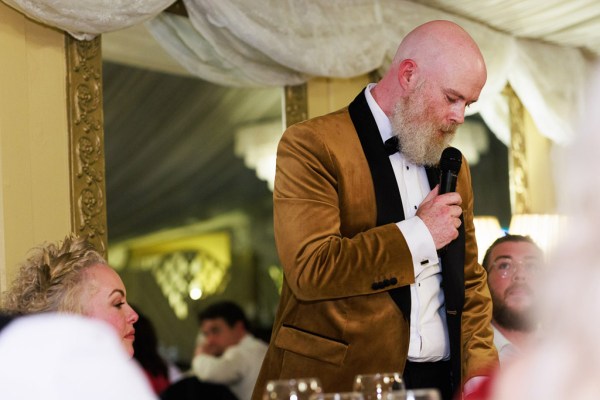 groom gives speech he speaks into microphone