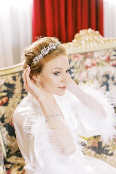 bride fixes her hair accessory while she sits