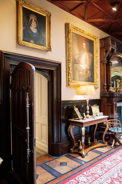 stately Victorian room with hanging portraits