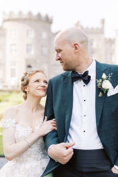 bride looks up at groom smiling