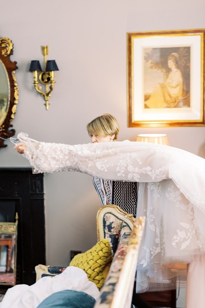 woman carries bridal gown dress