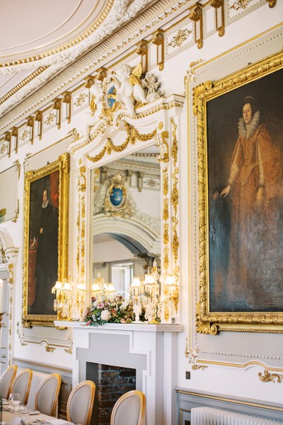 stately home interior portraits hanging on wall