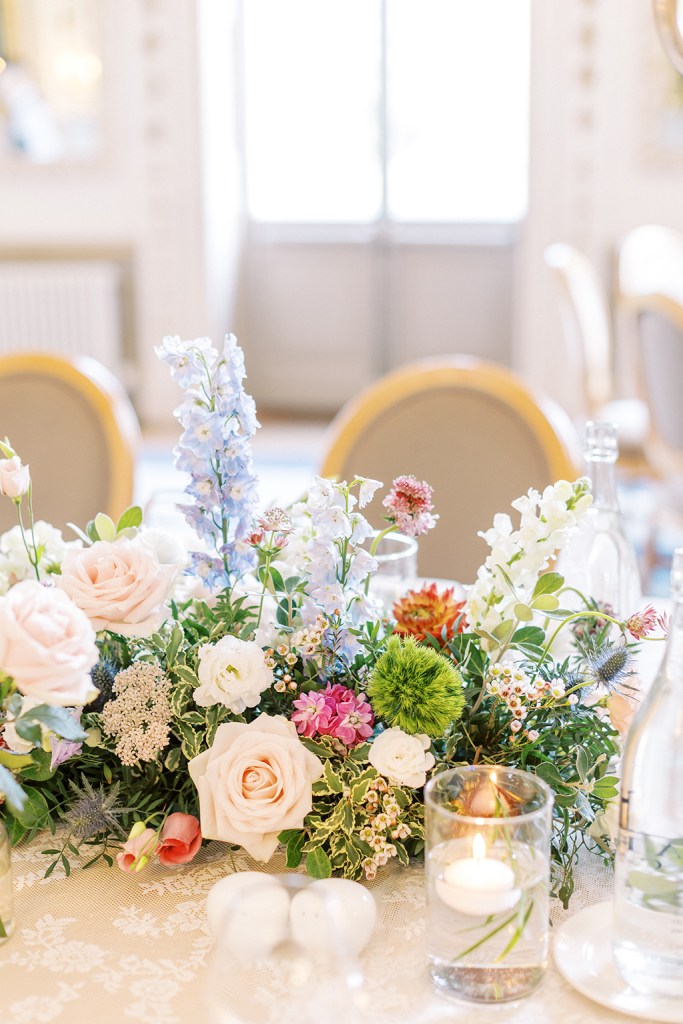 candles lit and colourful flowers laid out on table