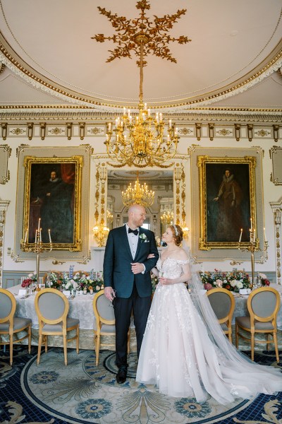 bride and groom walk in dining room setting interior