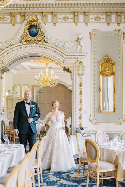 bride and groom walk in dining room setting interior