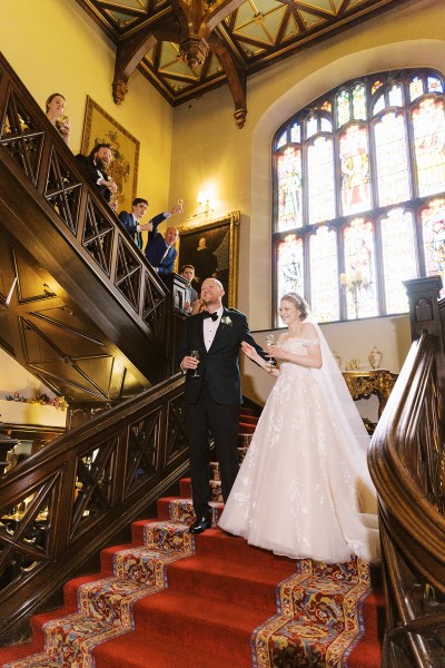 bride and groom stand on staircase