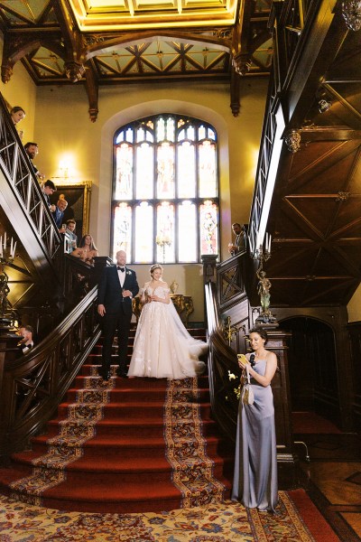 bride and groom stand on staircase