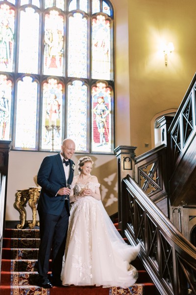 bride and groom stand on staircase