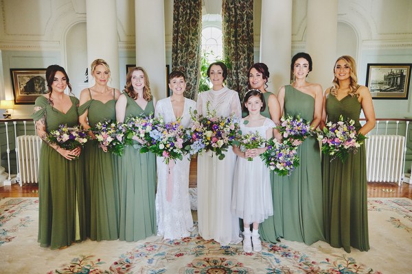 Brides bridesmaids little girl all holding bouquets flowers