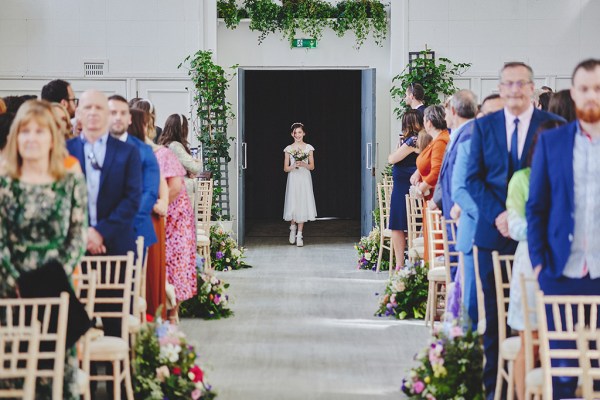 Flower girl begins walking down the aisle