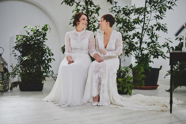 Brides sit at top of alter in front of guests