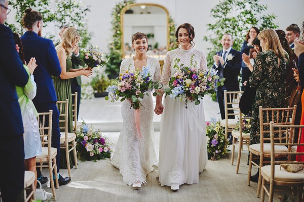 Brides exit wedding ceremony together