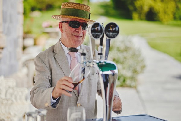 Man with straw hat smiles at the bar