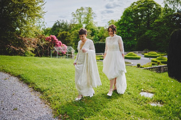 Brides walk on the grass garden setting and trees