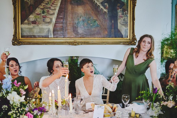 Woman in green with brides at table