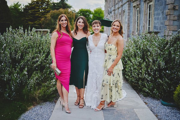 Bride and guests woman pose for a photo