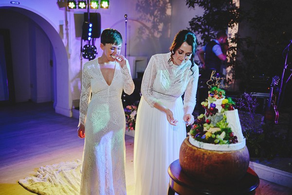 Two brides cut the fruit wedding cake