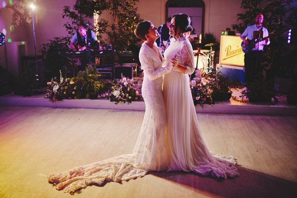 The two brides share their first dance on the dancefloor