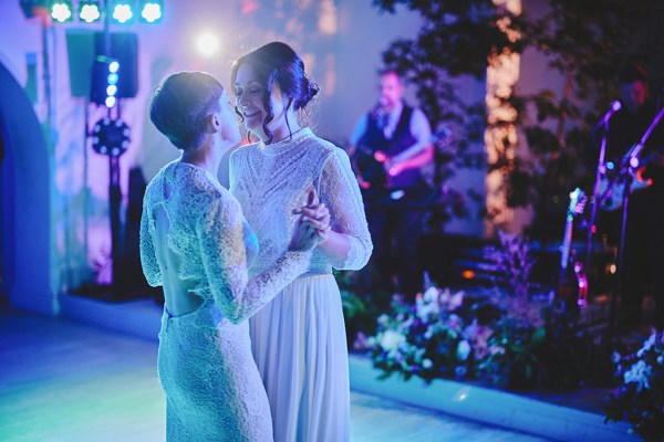 The two brides share their first dance on the dancefloor