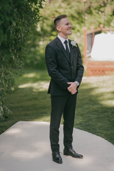 groom awaits his bride at the alter