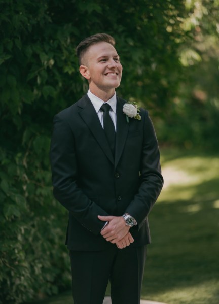 groom awaits his bride at the alter