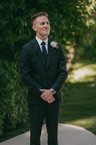 groom awaits his bride at the alter