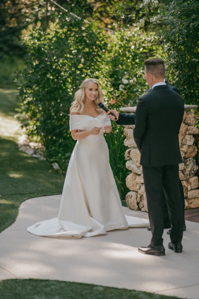 bride and groom standing at the alter giving vows microphone