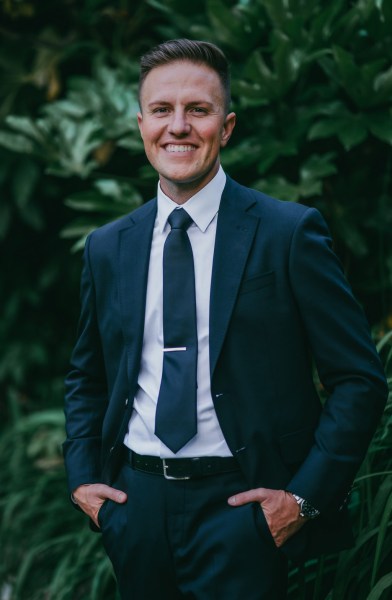 groom smiles in garden