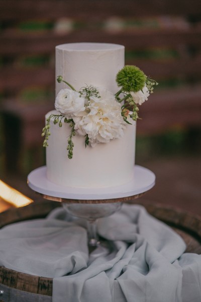 white wedding cake covered in flowers