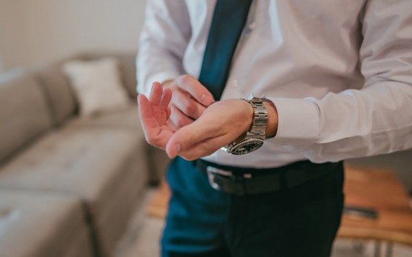 groom puts on his watch