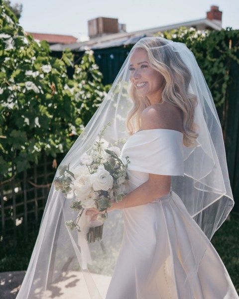 veil covers white roses flowers bouquet and face