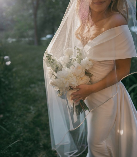 bride and veil detail she's holding bouquet