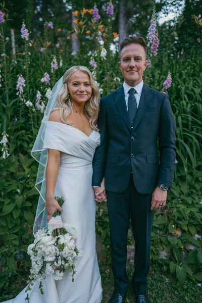 bride and groom giggle and laugh together in forest setting