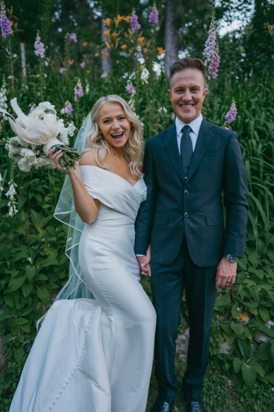 bride and groom giggle and laugh together in forest setting