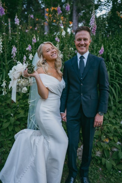 bride and groom giggle and laugh together in forest setting