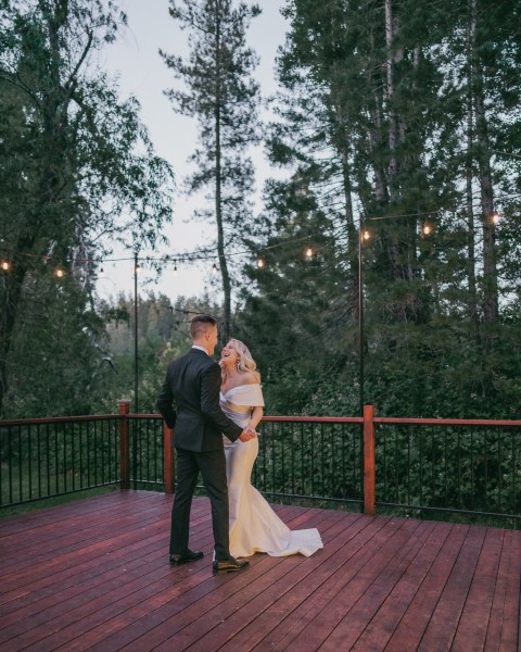 bride and groom dance on the boardwalk to forest balcony setting