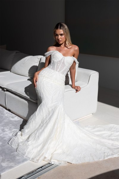 Sarah Alouache Femme Collection bridal dress bride sitting on sofa couch