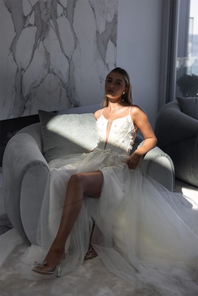 Sarah Alouache Femme Collection bridal dress bride sitting on sofa couch