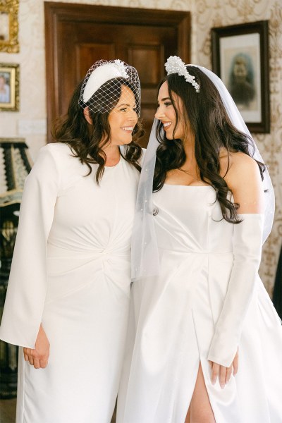 Mother and daughter face each other smile and laugh