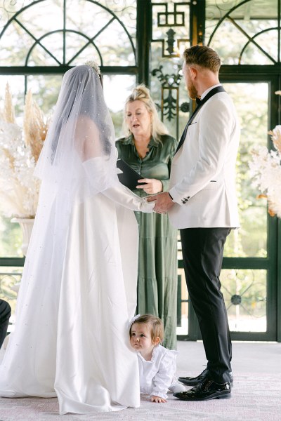 Bride and groom stand at the alter together