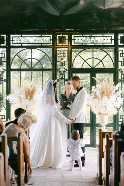 Bride and groom stand at the alter together