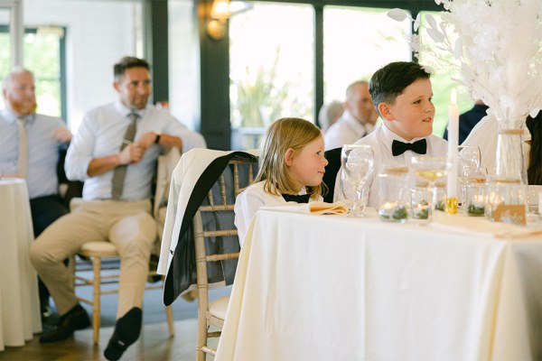 Two little boys sit at the dining room table