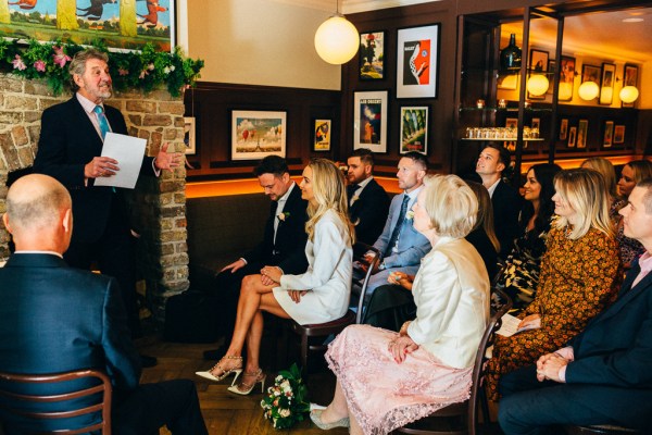 bride groom and family members seated during ceremony celebrant gives speech